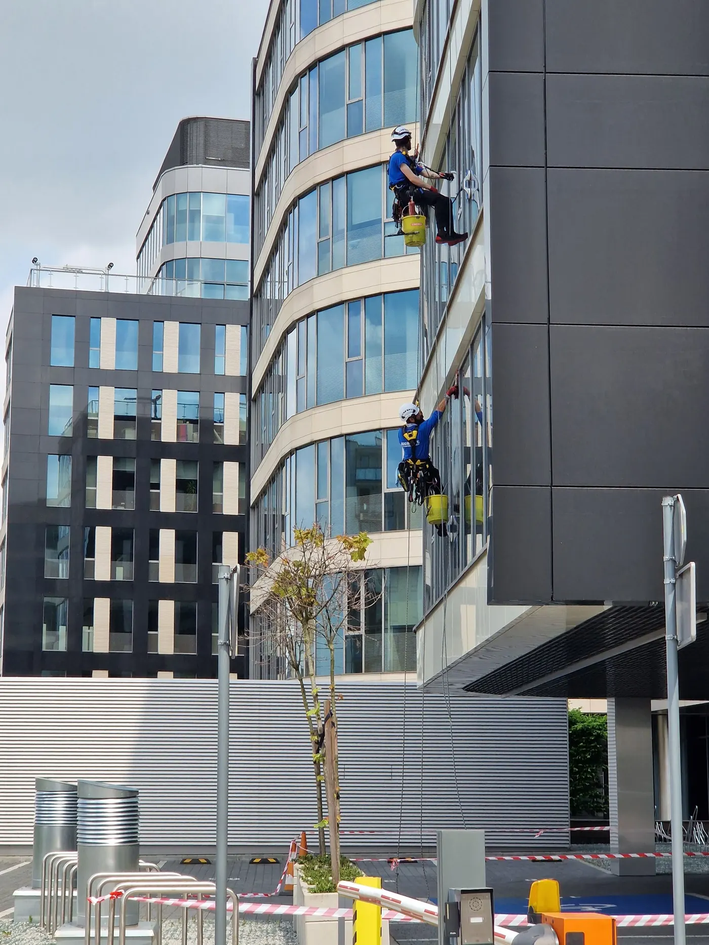 Facility crew cleaning a building facade