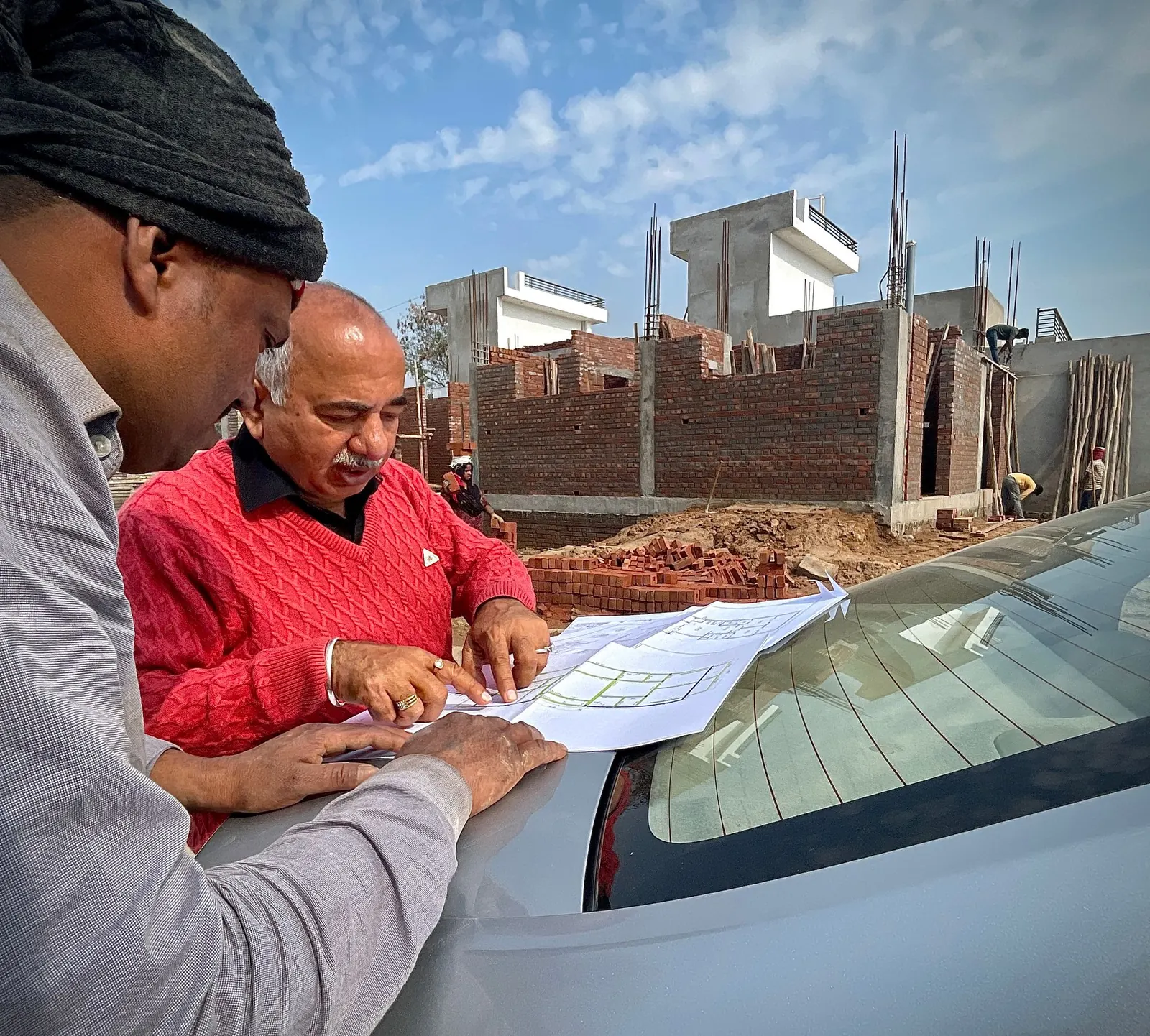 Advisor and client reviewing plans on site